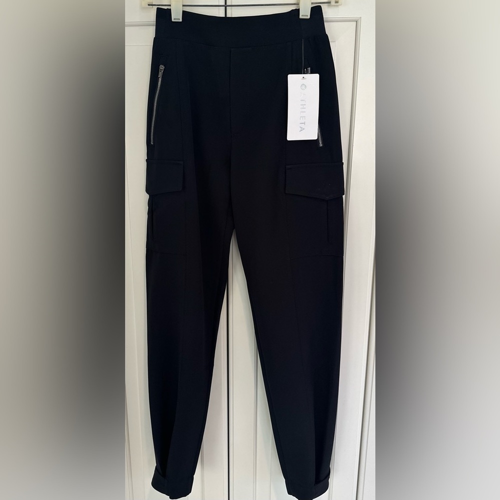 NWT Athleta Endless Cargo Black Pants. Size 0 
2 snaps on hem. Side zippers